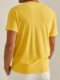 Back view of model wearing CloudKnit Shortsleeve in vibrant yellow, soft lightweight fabric for everyday wear.