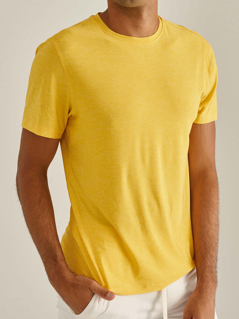 Model wearing CloudKnit Shortsleeve in bright yellow, with lightweight and breathable fabric.