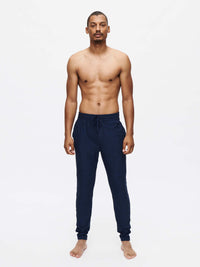 Model standing in CloudKnit Slim Sweatpant in Navy, featuring a custom-fit drawstring waistband.