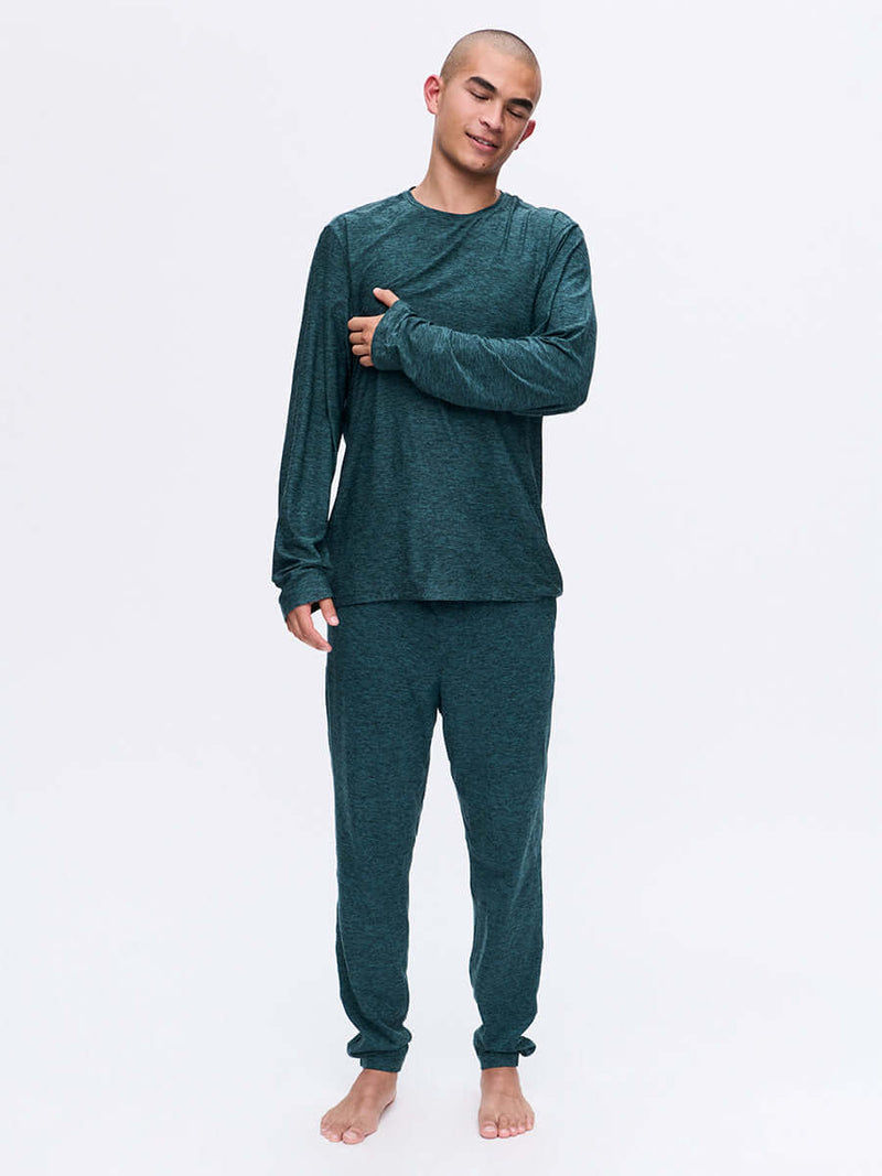 Model wearing CloudKnit Slim Sweatpant in Dark Teal, soft lightweight fabric for lounging.