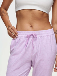 Woman wearing CloudKnit Sweatpant with a drawstring waistband and pockets in soft lavender color.
