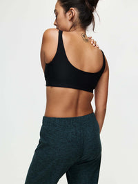 Back view of a model wearing the CloudKnit Wide Leg Pant and a black sports bra, with comfort and style.