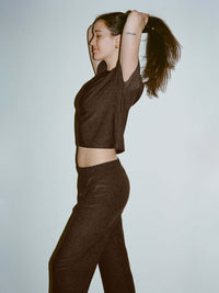 Model stretching in CloudKnit Wide Leg Pant, showing soft, lightweight fabric and relaxed fit for lounging.