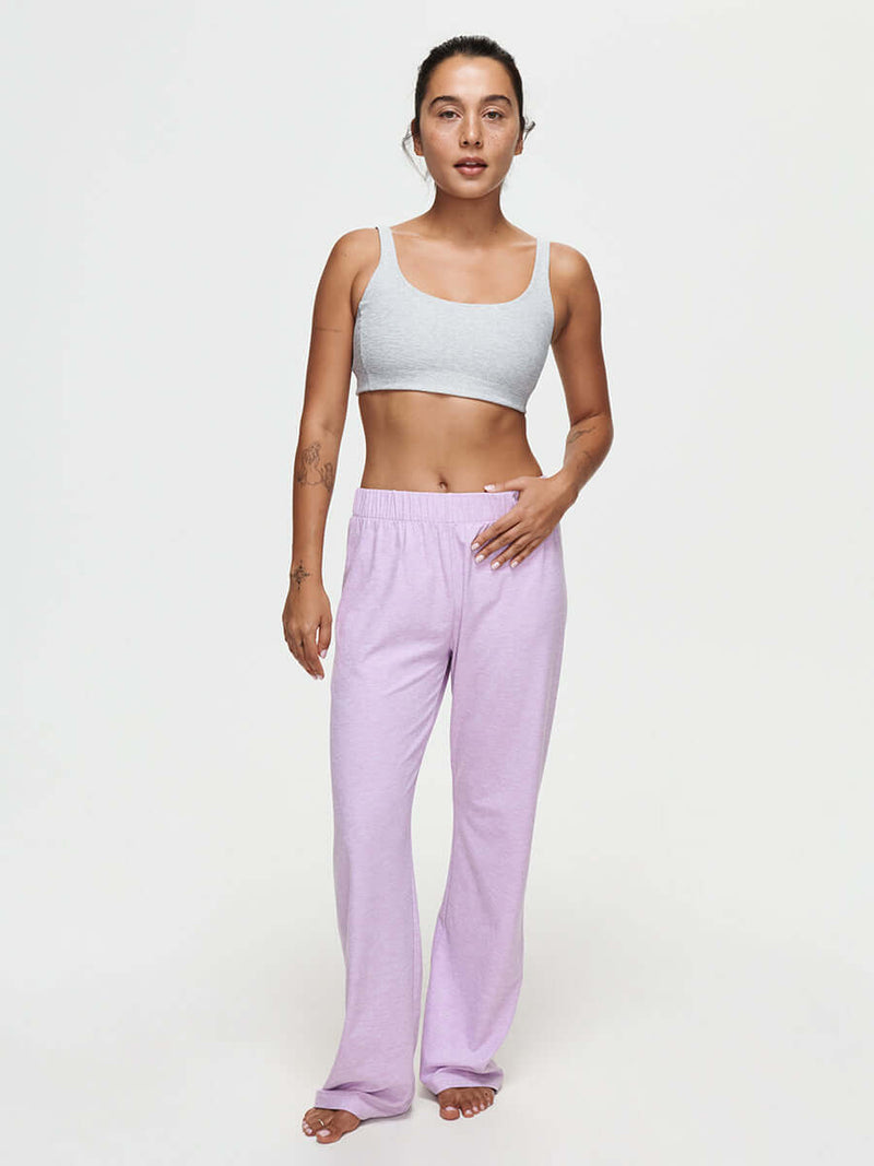 Model wearing CloudKnit Wide Leg Pant in lavender with a grey crop top, highlighting comfort and style.