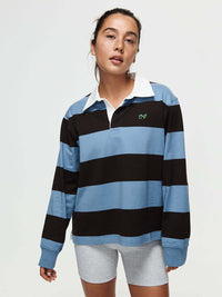 Model in the Club Polo with ribbed cuffs and woven collar, built for fall layering.