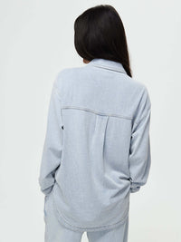 Back view of Desert Shirt in Light Blue, with an oversized fit and curved hem.
