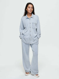 Model wearing Desert Shirt in Light Blue, featuring brushed silver buttons and an oversized fit.