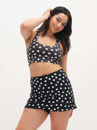 Model wearing Doing Things Bra in Black Polka Dot, featuring a sleek crop design and a supportive fit.