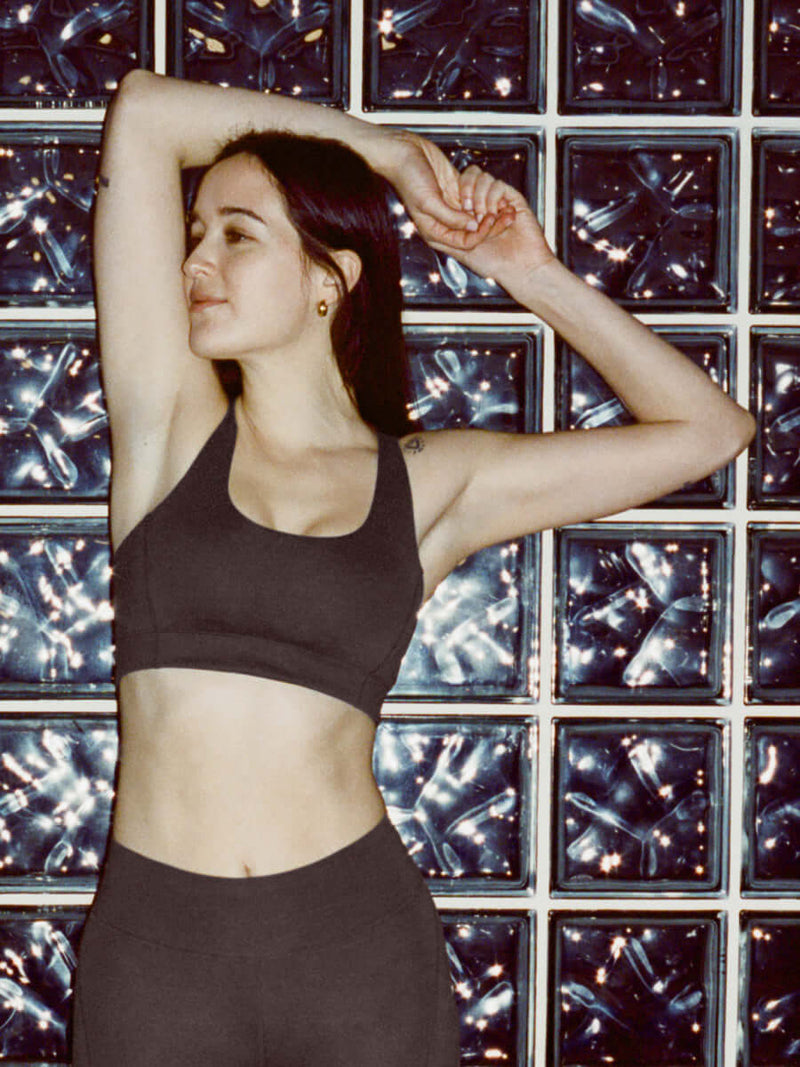 Model stretching in Doing Things Bra in Slate Grey with removable pads and mesh detailing.