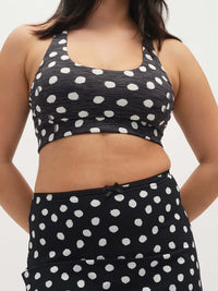 Model wearing Doing Things Bra in Black with white polka dots, featuring a comfortable, supportive fit.