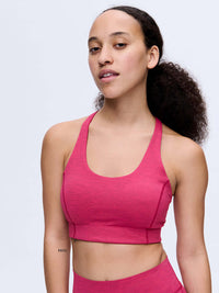 Model wearing Doing Things Bra in Pink with supportive straps and breathable mesh backing.