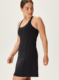Model wearing Doing Things Dress in Black with breathable fabric and sporty fit, for active days.
