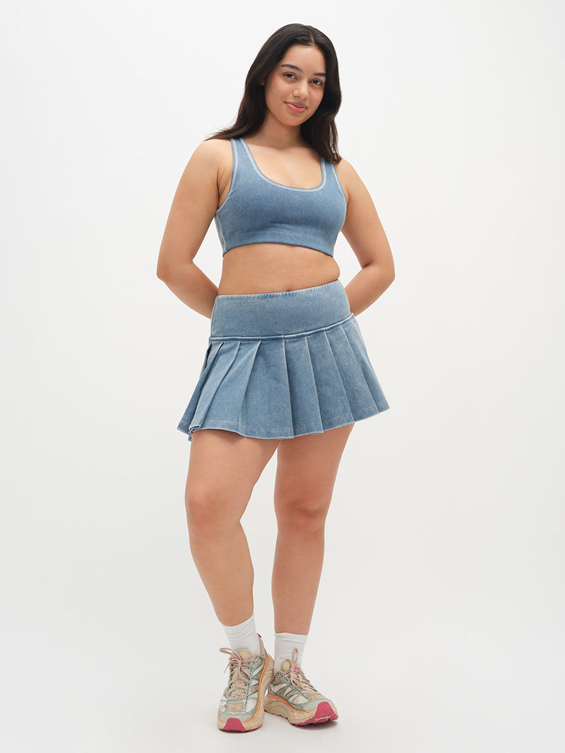 Model wearing Doing Things 3" Skort in Denim Blue, featuring a pleated skirt and built-in shorts.