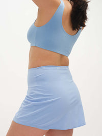 Model in side view wearing Double Dip Bra in Cotton Candy, with a soft scoop neckline and medium support.