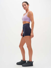 Model wearing Double Dip Bra in Cotton Candy with wide shoulder straps, paired with high-waisted shorts.
