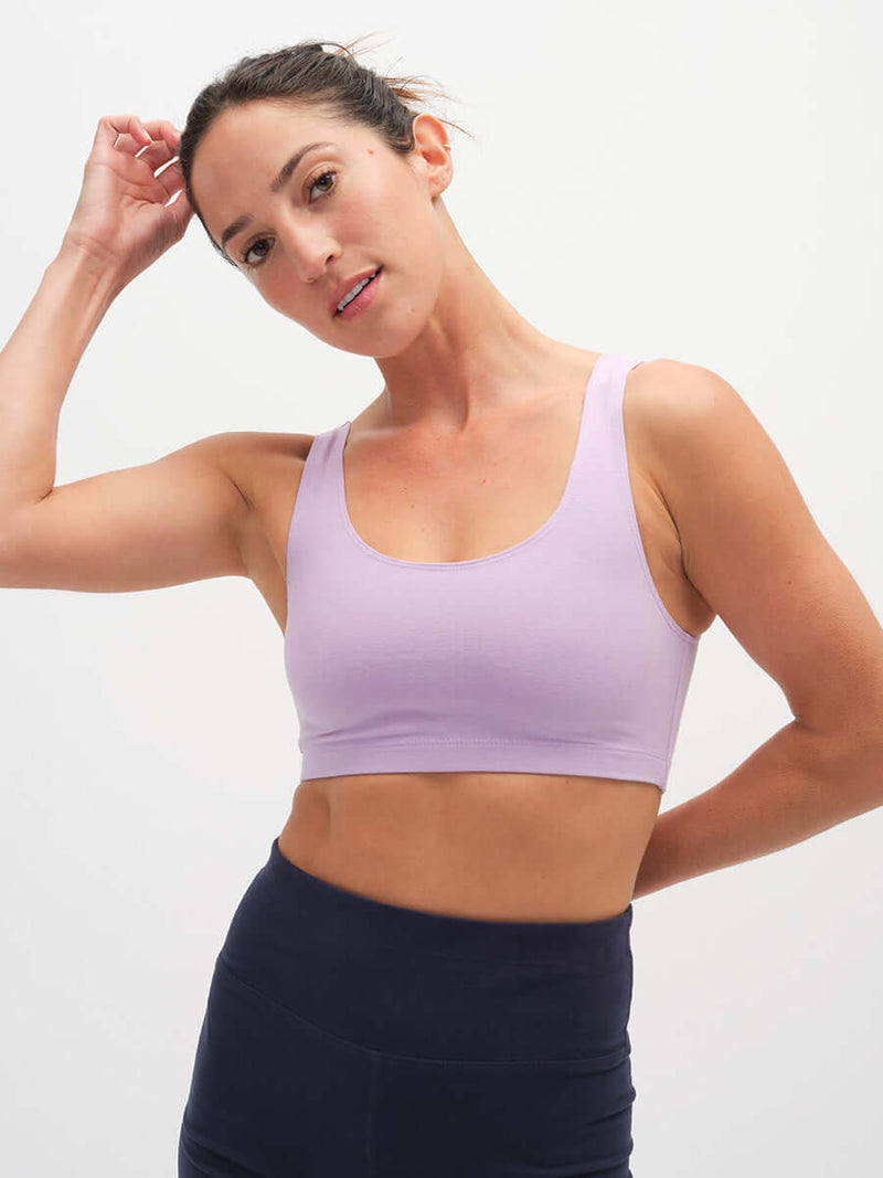 Model wearing Double Dip Bra in Cotton Candy, showing a double scoop neckline and wide shoulder straps.