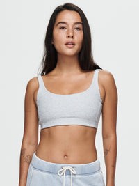 Model wearing Double Time Bra in Grey, featuring a double scoop design and medium support for activewear.