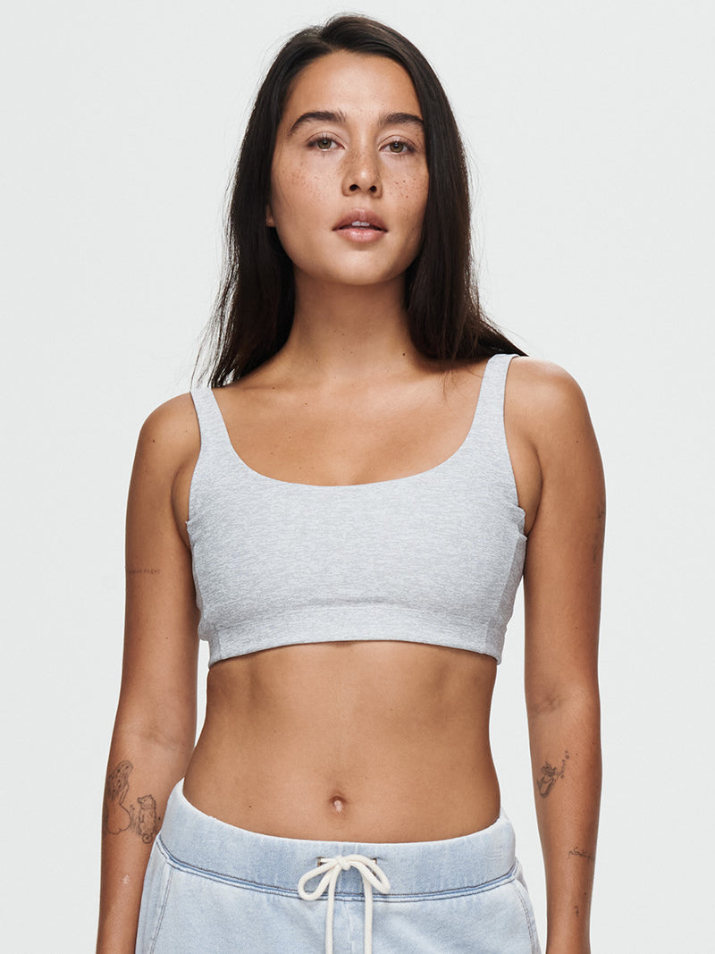 Model wearing Double Time Bra in Grey, featuring a double scoop design and medium support for activewear.