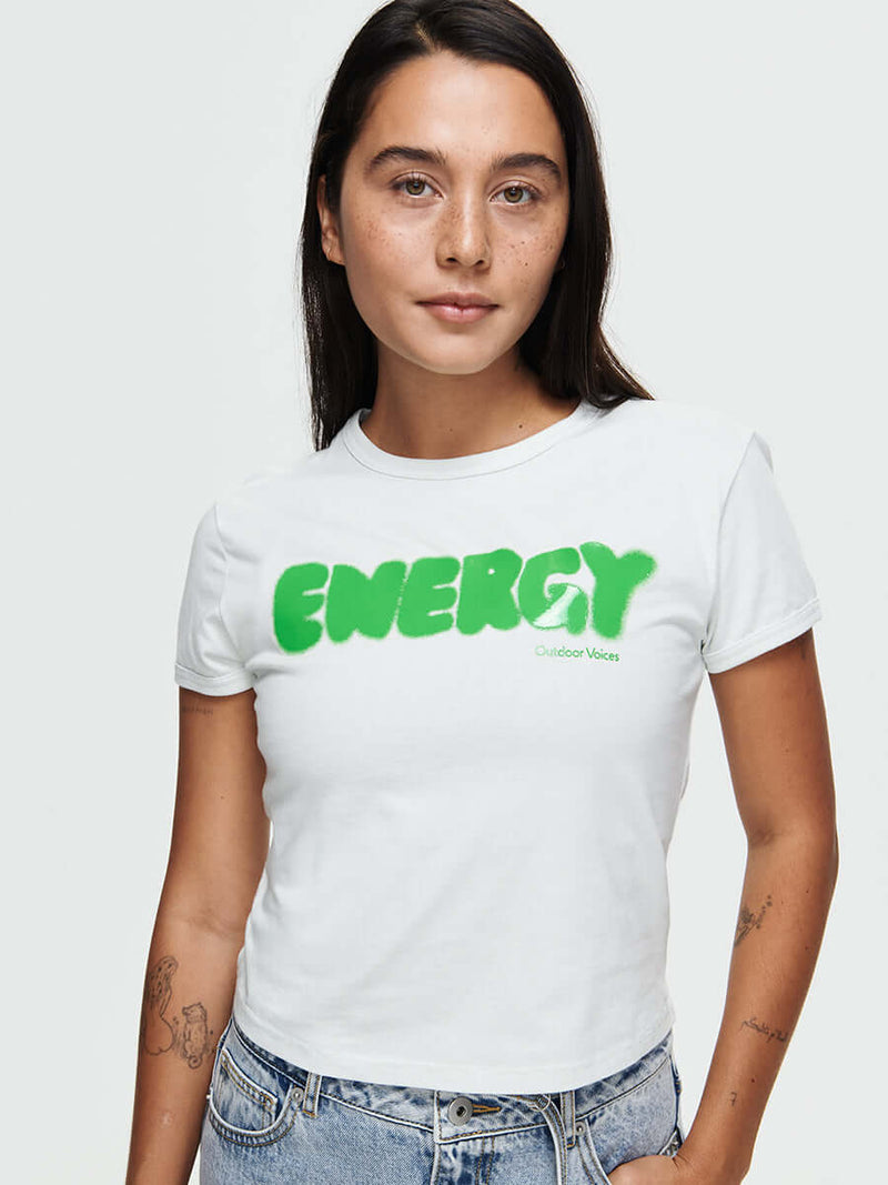 Model wearing Energy Tee in white, featuring ENERGY graphic in futuristic silicone print.