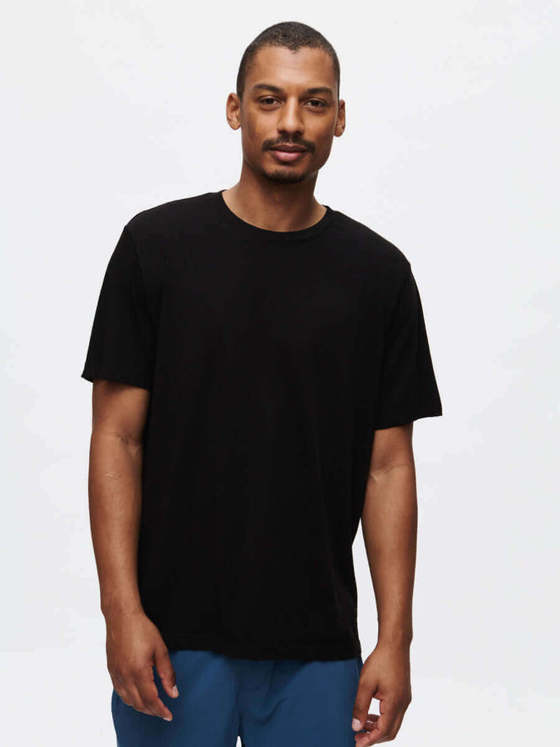 Model wearing Everyday Classic Shortsleeve in Black, soft and lightweight organic cotton jersey.