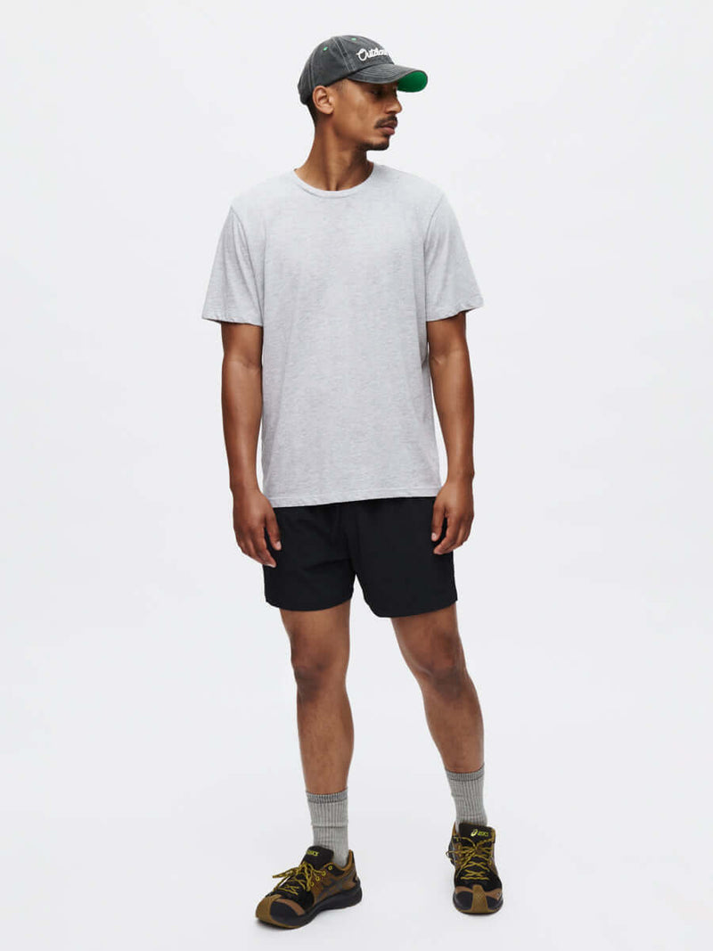 Model standing in Everyday Classic Shortsleeve in Light Gray, soft organic cotton jersey for low-sweat activities.