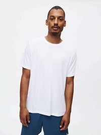 Model standing in Everyday Classic Shortsleeve, soft white organic cotton jersey, ideal for low-sweat recreation.