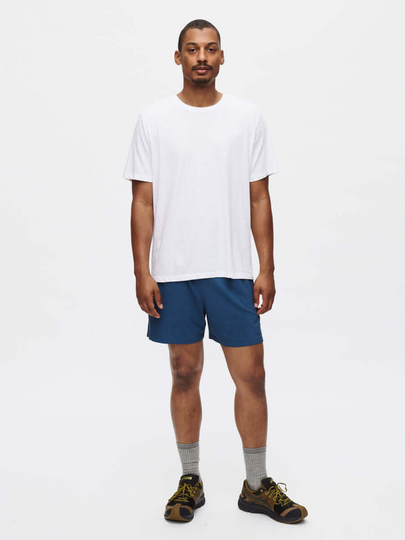 Model standing in Everyday Classic Shortsleeve in White, soft and breathable organic cotton for activewear.