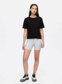 Everyday Shortsleeve in black, paired with grey shorts, demonstrating a relaxed fit and casual style.