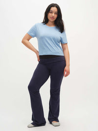 Model posing in Everyday Shortsleeve in Light Blue, featuring a relaxed fit and slight crop with flared pants.