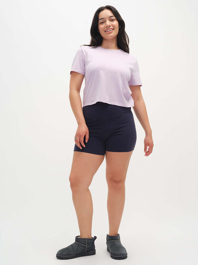 Model in relaxed pose wearing Everyday Shortsleeve in Lavender, slight crop with relaxed fit, styled for everyday wear.