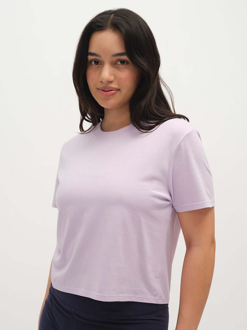 Model wearing Everyday Shortsleeve in Lavender, featuring a relaxed fit and slight crop for everyday comfort.