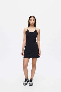 Model wearing The Exercise Dress in Black with adjustable straps and built-in shorts liner, ready for any activity.