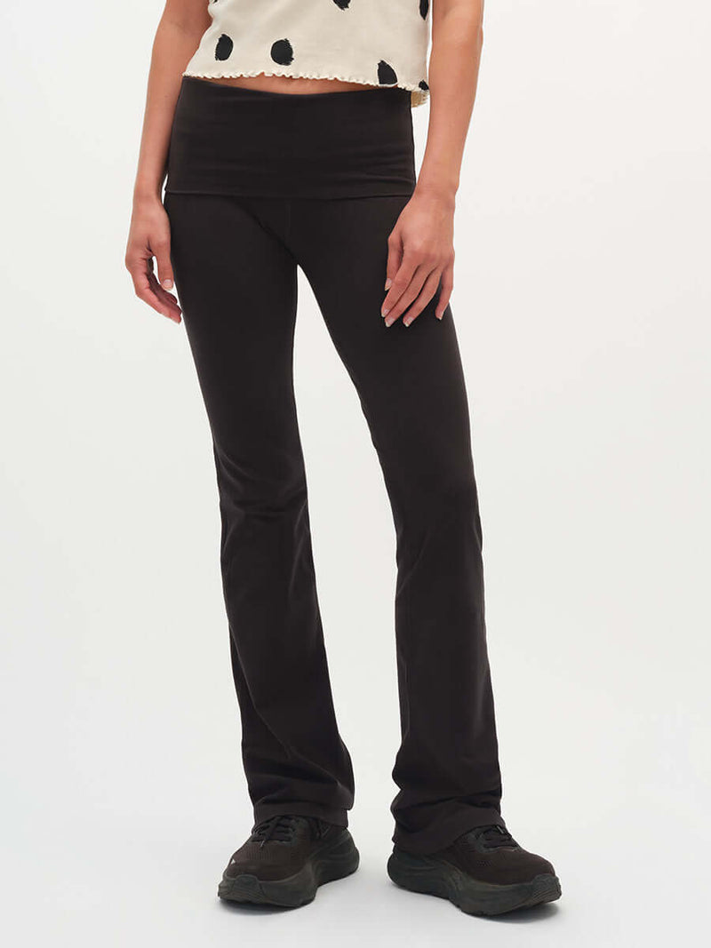 Model standing in Flared Legging in Black, featuring an extra-tall waistband for a customizable fit.