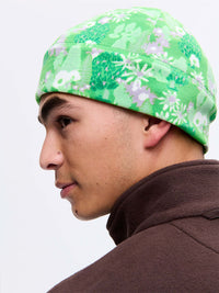 Side view of a man wearing Frosted Beanie in Green, featuring a soft fleece fabric with Elf Garden print.