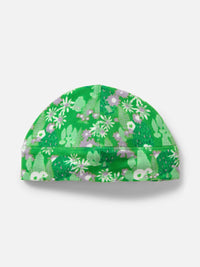 Top view of Frosted Beanie in green, featuring an exclusive Elf Garden print with pine trees and daisies.