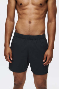 Model wearing High Stride 5" Short with Pockets in Black, showing lightweight training fabric and elastic waistband.