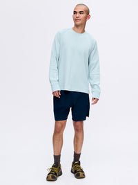 Model in light blue long sleeve shirt with High Stride 7" Short with Pockets in navy, styled for training.