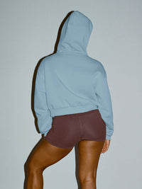Back view of The Diamanté Doing Things Hoodie in Sky Blue, featuring a cropped length and hood.