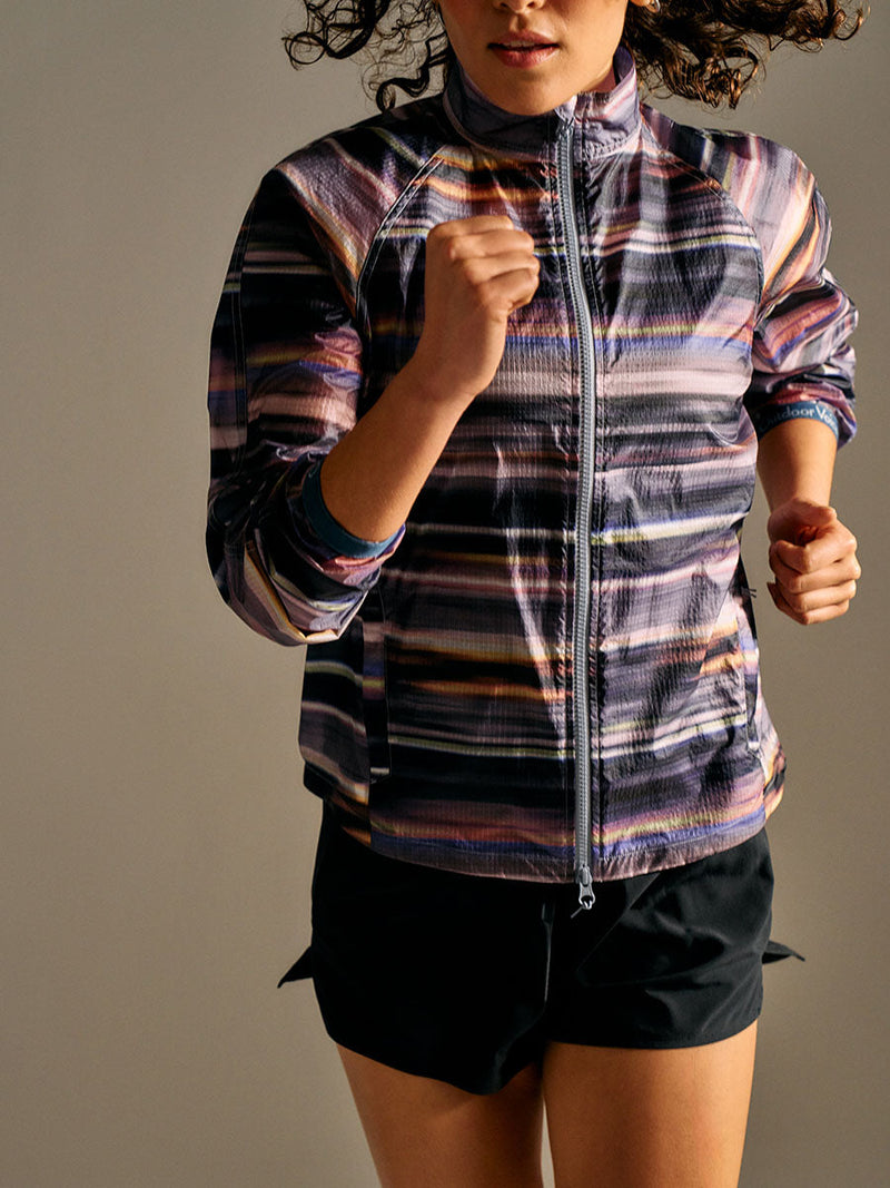 Model running in Jog Jacket with colorful stripes, quick-drying and wind-resistant fabric for performance.
