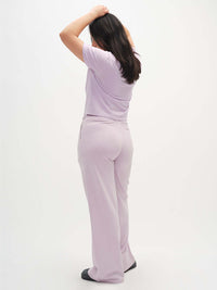 Back view of model wearing Malibu Sweatpant in Lavender, highlighting the wide leg and soft fabric.