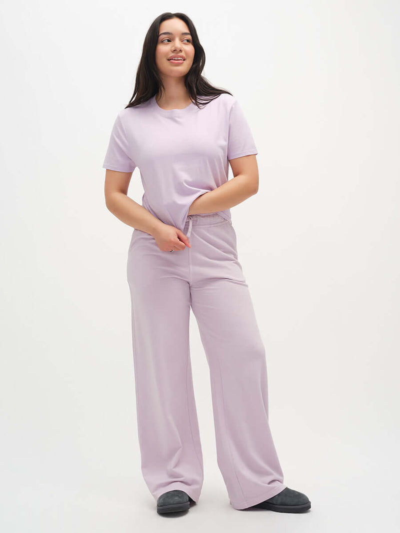 Model wearing Malibu Sweatpant in Lilac, with wide leg style and relaxed fit for lounging.