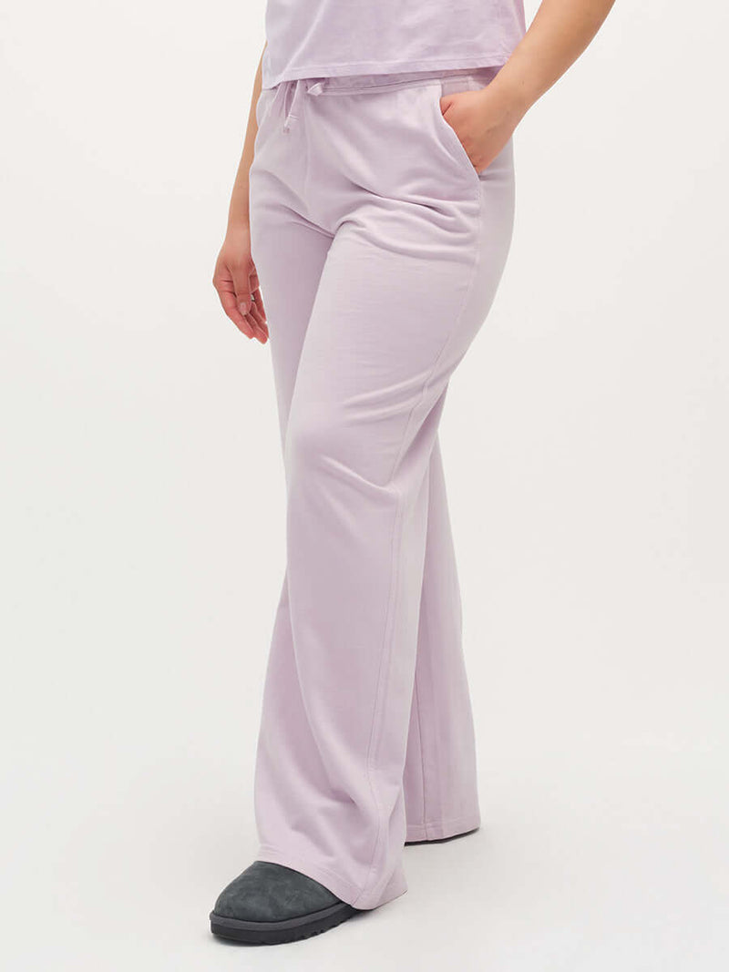 Model wearing Malibu Sweatpant in Light Purple, featuring wide leg and side pockets.