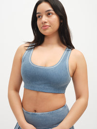 Model wearing Orbit Bra in Denim, featuring a soft-fit elastic and cooling performance fabric.