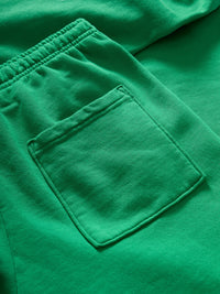 Close-up of Pickup Organic Sweatpant in Bright Green, showing the spacious back pocket detail.
