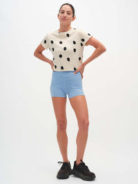 Model wearing Polka Tee in Cream, featuring a playful polka dot print and a relaxed fit.