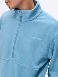 Model wearing RecFleece 1/2 Zip in Light Blue with a front half-zip and soft fleece fabric.