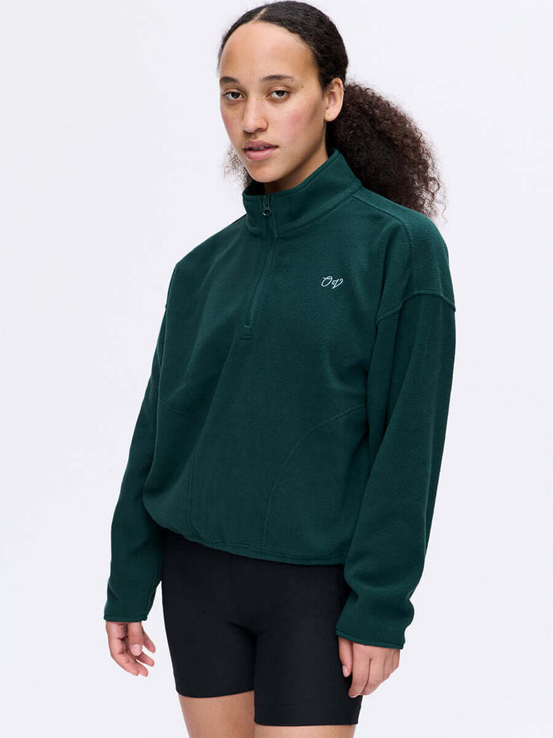 Model wearing RecFleece 1/4 Zip in Deep Teal, with the front ¼ zip and relaxed fit.