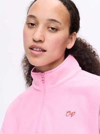 Close-up of model in pink RecFleece 1/4 Zip, featuring a soft texture and ¼ zip collar.