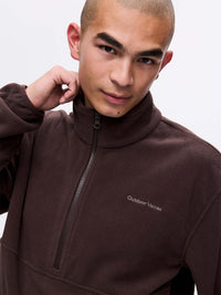 Model wearing RecFleece 1/2 Zip in Chocolate Brown, with a front half zip collar and relaxed fit.