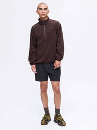 Model standing in RecFleece 1/2 Zip in Brown, featuring front ½ zip and a relaxed fit, styled for everyday wear.